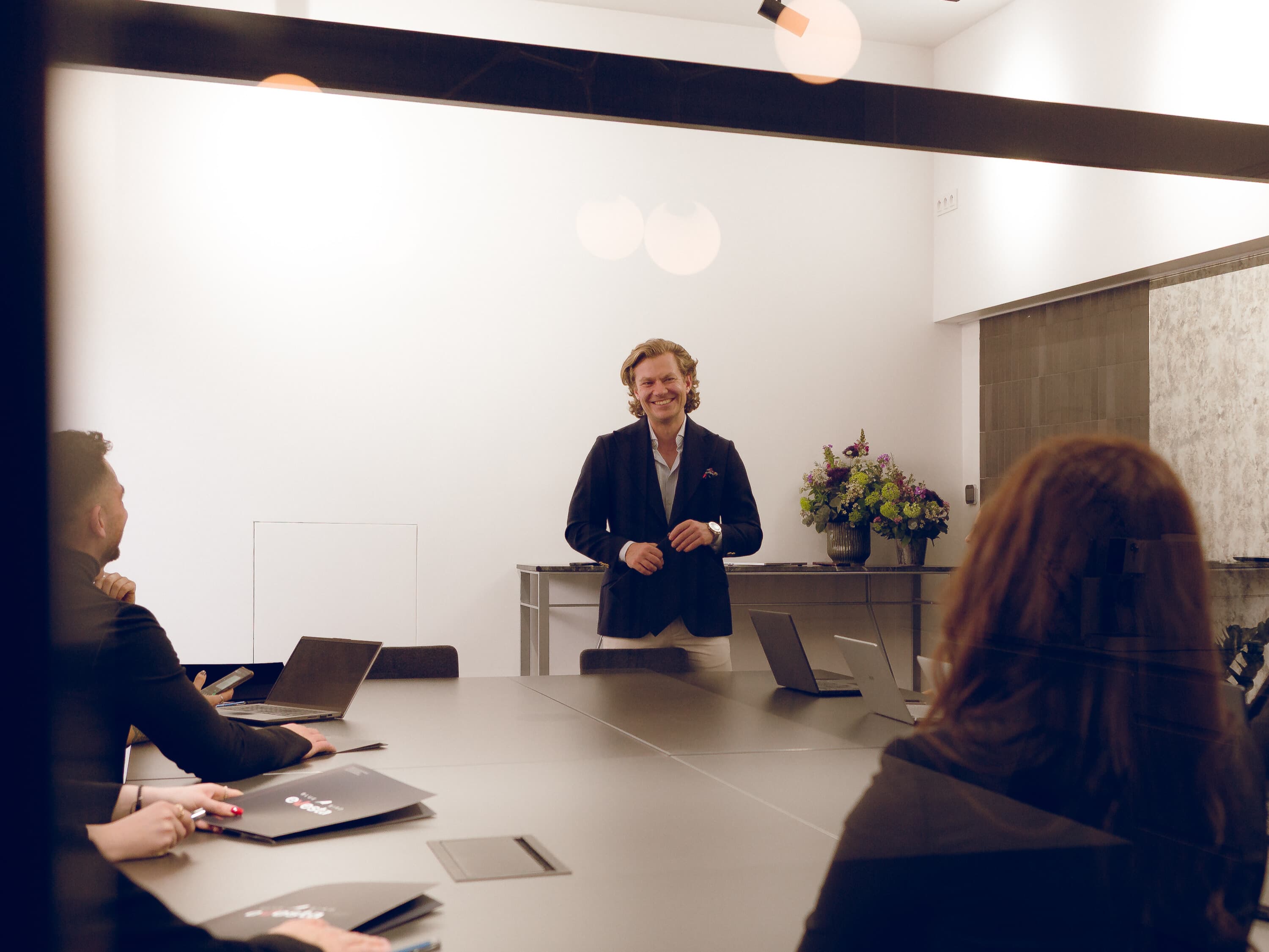 A man gives a presentation to a team in a conference room.