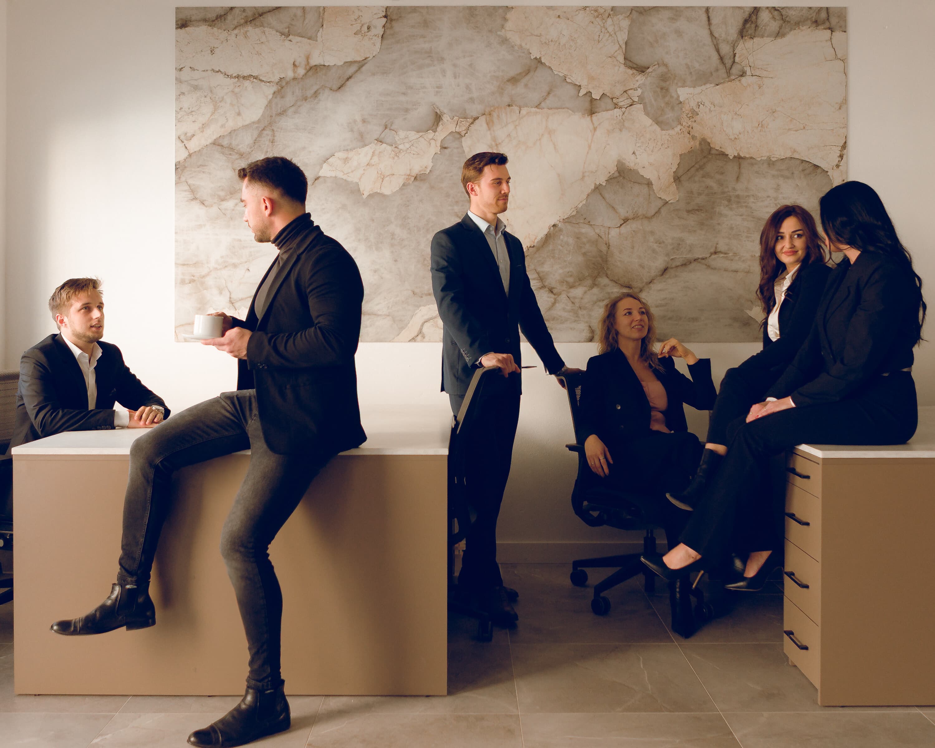 A group of colleagues during an informal discussion in a modern office.